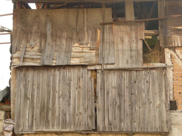 Damaged wooden wall with very worn, inconsistent surface.