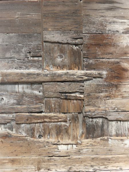 Wooden plank texture set in irregular formation with very rough, worn surface.