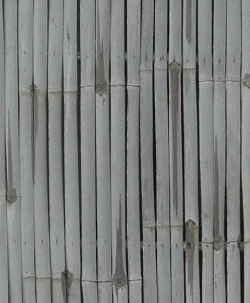 Thin wooden planks in consistent grey color set in vertical formation.