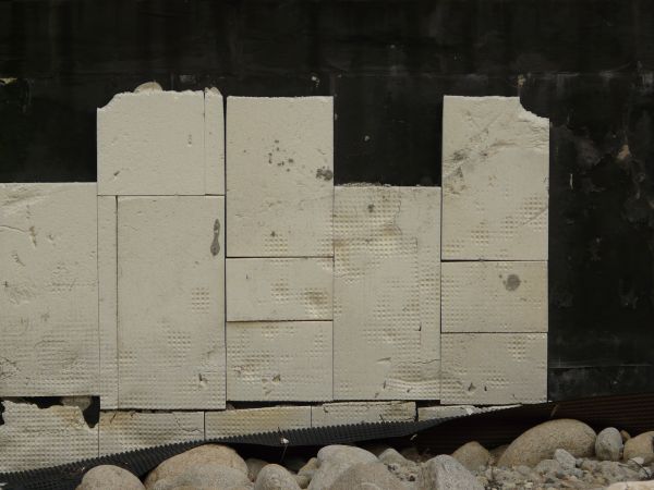 White brick texture, with a recessed texture in its surface, and partially covered by a black material.