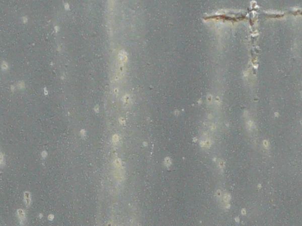 Smooth metal texture with streaks and scratches.