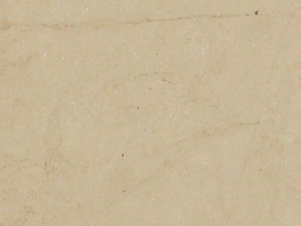 Tan paper texture with faintly visible dark marks and a torn top edge.