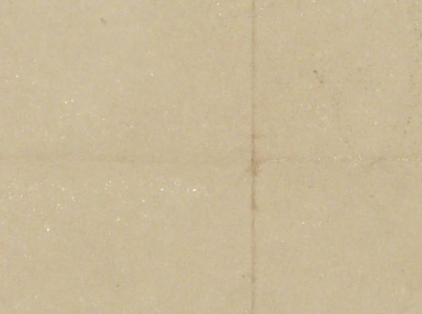 Tan paper texture with fold marks faintly visible and an uneven bottom edge.