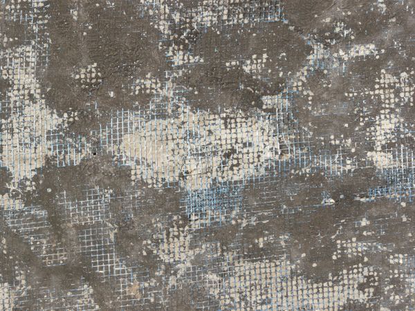 Plastic mesh texture embedded in dirty rubber and plaster.
