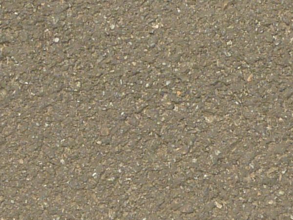 Road texture with dark areas of asphalt patching holes, thin crack extending from the patches, and a small, unfilled hole.