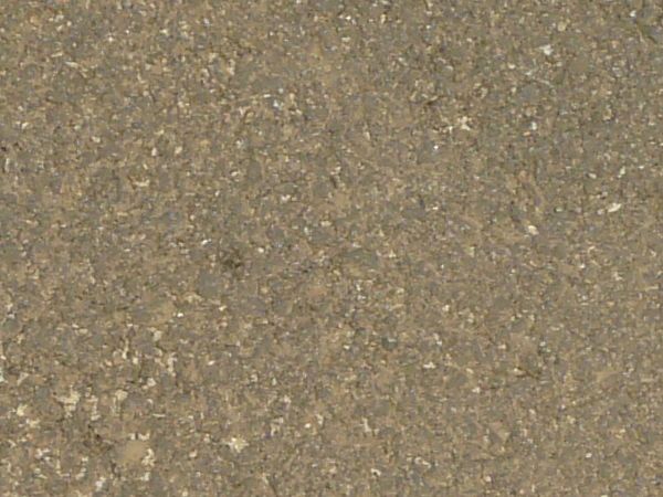 Road texture with dark areas of asphalt patching holes, thin crack extending from the patches, and a small, unfilled hole.