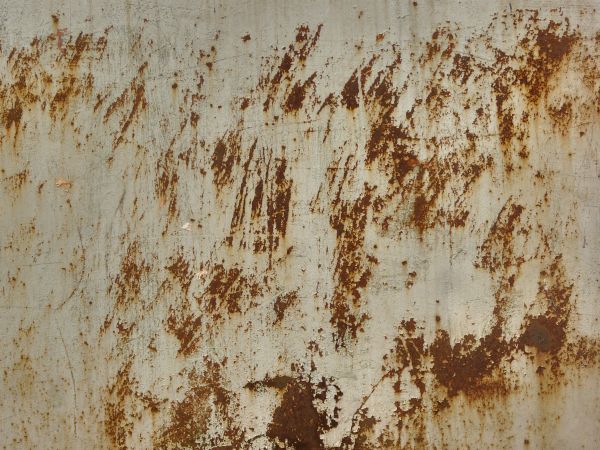 White metal texture with large, irregular patches of red rust and many small rusted scratches.
