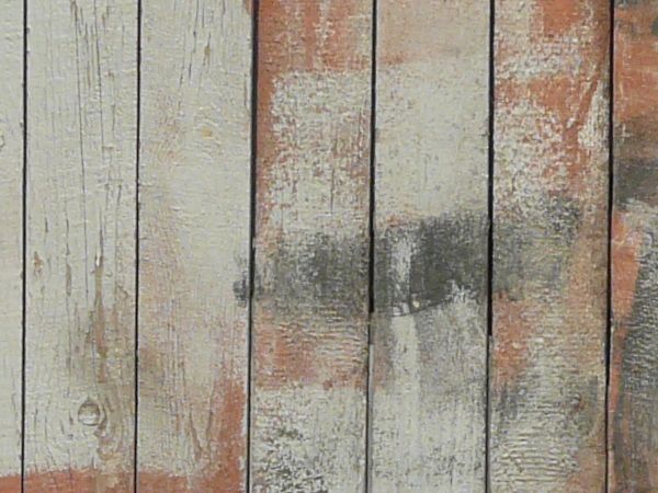 Texture of wooden gate made of planks set in vertical fashion with white paint on surface.